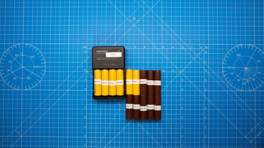 Batteries on a blue grid with a charger