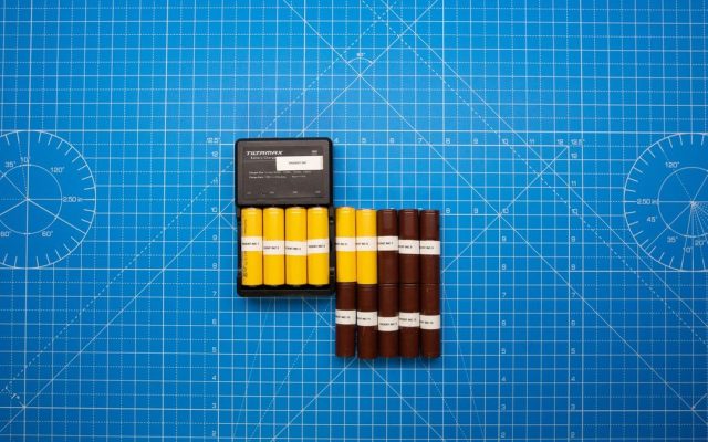 Batteries on a blue grid with a charger