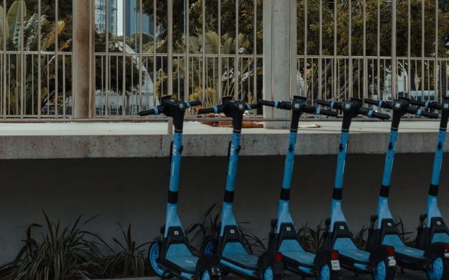 Blue electric scooters parked in a row