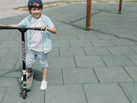 Boy riding a scooter in a park