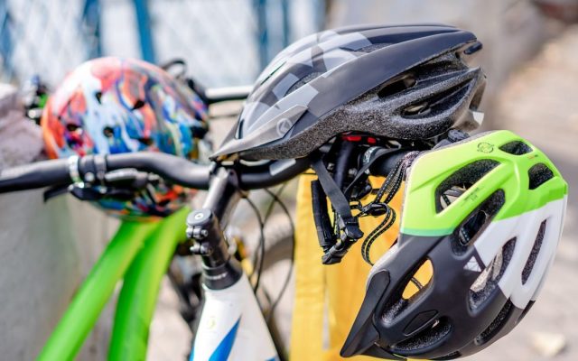 Brightly coloured bicycle helmets on handlebars