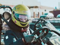 Child in a helmet ready to race a go-kart