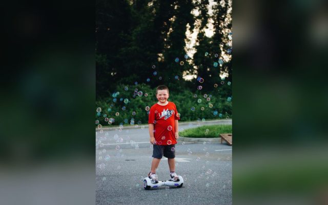 Child on a hoverboard surrounded by bubbles