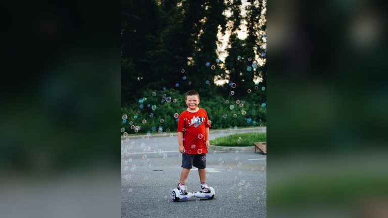 Child on a hoverboard surrounded by bubbles