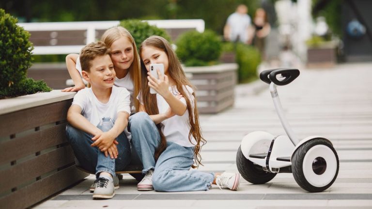 Children taking a selfie with a self-balancing scooter