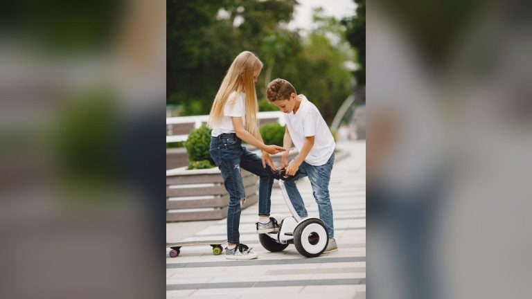 Children with a skateboard and scooter in a park