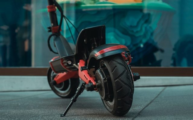 Close-up of a dual-motor electric scooter's rear wheel and suspension