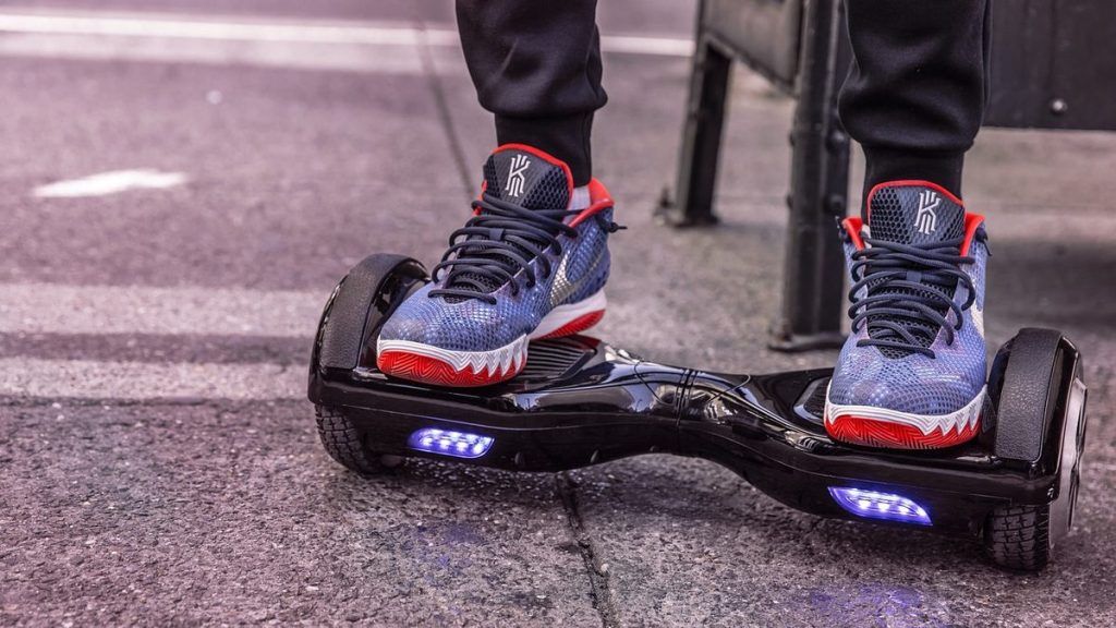 Close-up of sneakers on a hoverboard with LED wheels