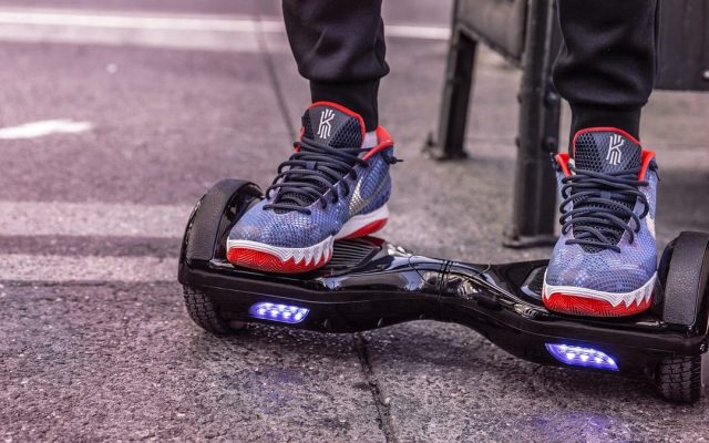 Close-up of sneakers on a hoverboard with LED wheels