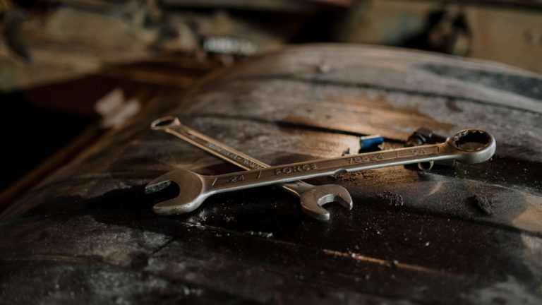 Close-up of wrenches on a workshop surface