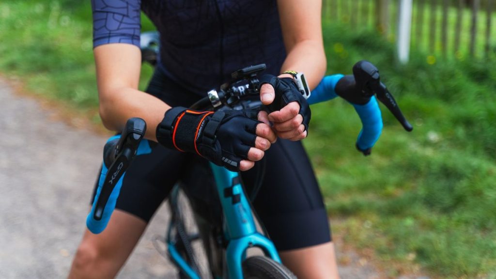Cyclist's gloved hands on handlebars