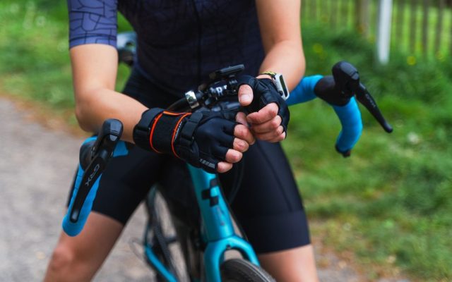 Cyclist's gloved hands on handlebars