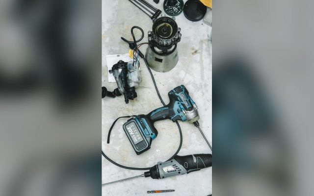 DIY repair tools and disassembled appliance parts