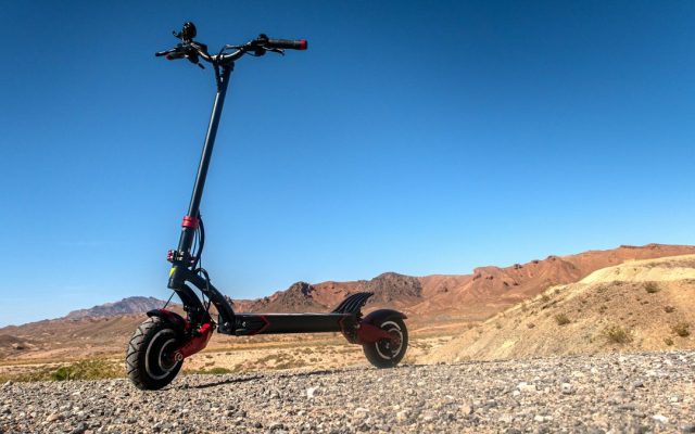 Dual-motor electric scooter parked in the desert