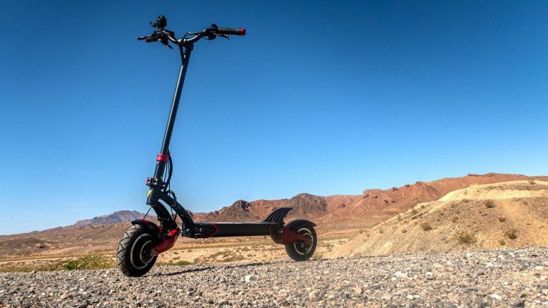 Dual-motor electric scooter parked in the desert