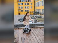 Girl riding a hoverboard on a wooden deck