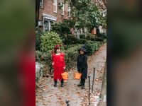 Girls in witch and devil costumes trick-or-treating