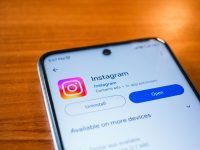 Instagram open on a smartphone on a wooden table
