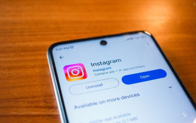 Instagram open on a smartphone on a wooden table