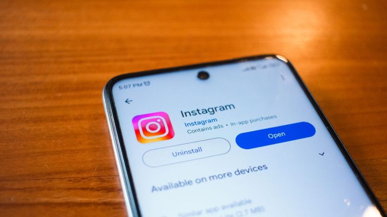 Instagram open on a smartphone on a wooden table