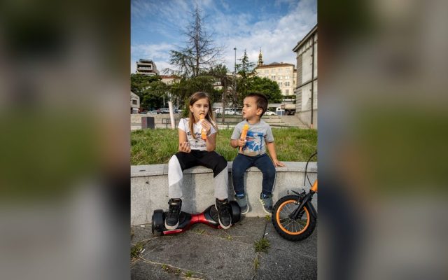 Kids eating ice cream with a hoverboard beside them