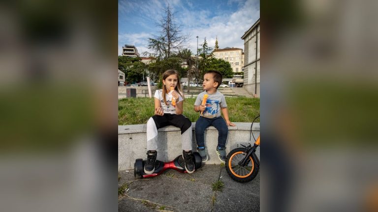 Kids eating ice cream with a hoverboard beside them