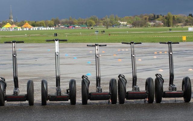 Line of self-balancing scooters parked at an event