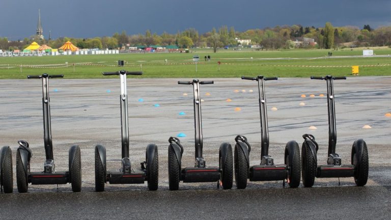 Line of self-balancing scooters parked at an event