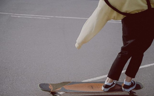 Longboarder skating through the city