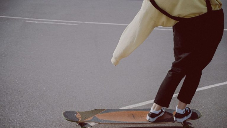 Longboarder skating through the city