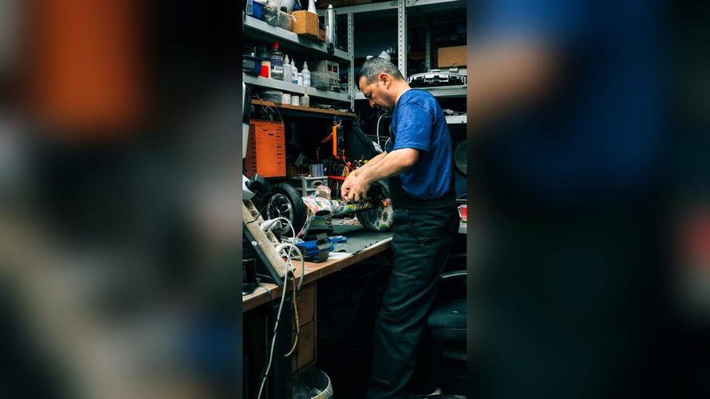 Man repairing electronics in a workshop