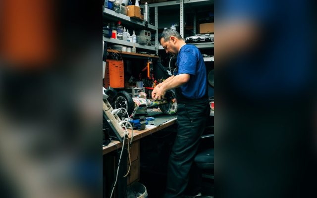 Man repairing electronics in a workshop