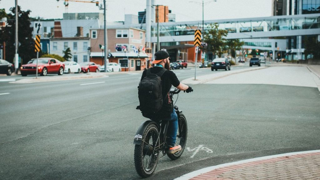 Man riding a bicycle with a backpack