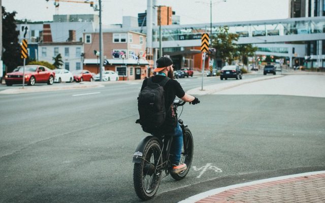 Man riding a bicycle with a backpack