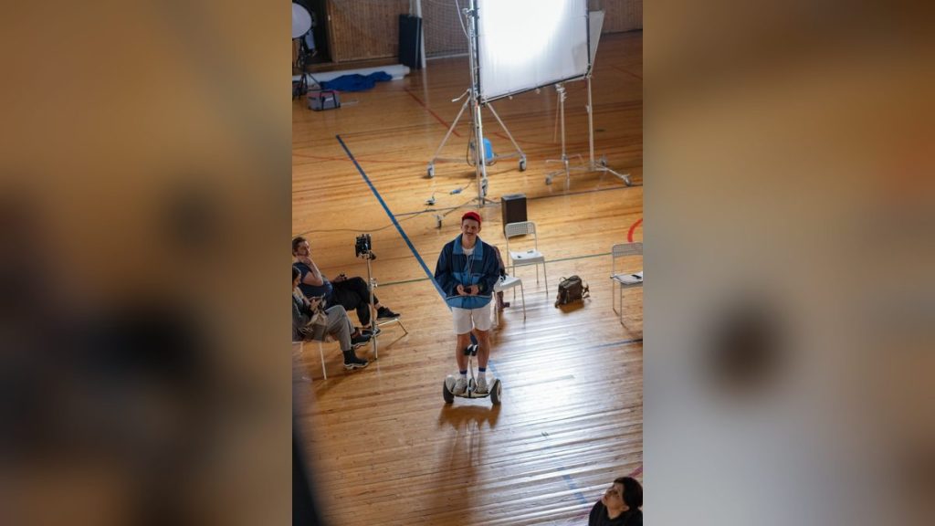 Man riding a self-balancing scooter in a studio