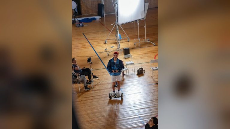 Man riding a self-balancing scooter in a studio