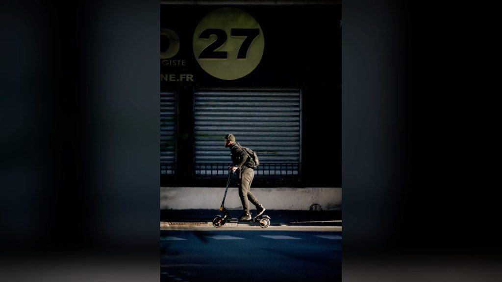 Man with a backpack riding an electric scooter