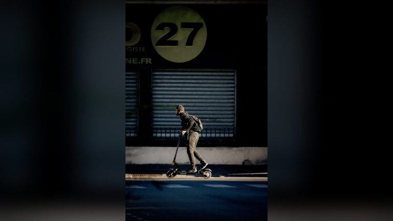 Man with a backpack riding an electric scooter