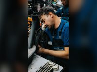 Mechanic repairing an electric scooter in a workshop