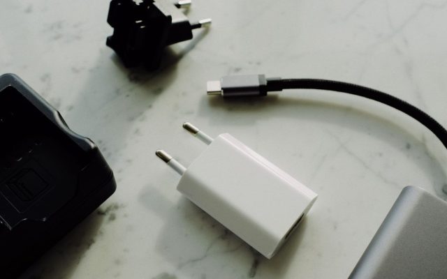 Modern charger, adapter and battery pack on a marble table