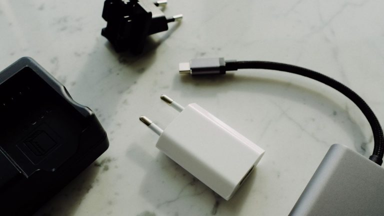 Modern charger, adapter and battery pack on a marble table