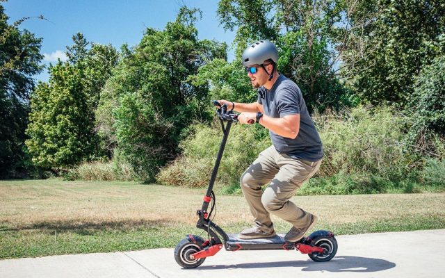 Rider carving on a dual-motor electric scooter