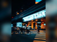Rider crossing a busy intersection at night on an e-scooter