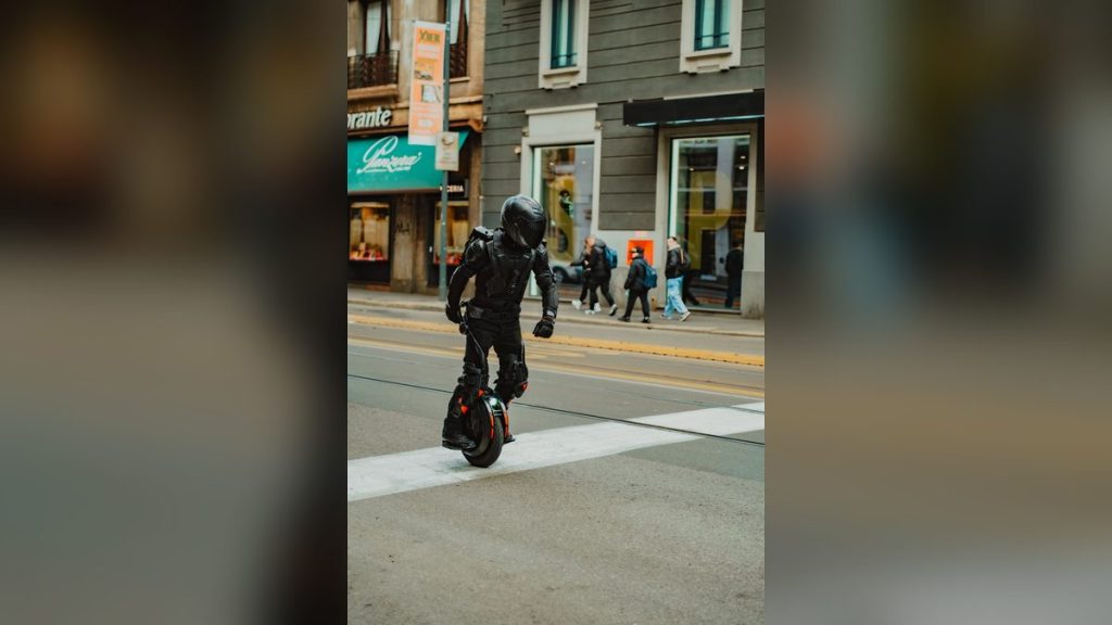 Rider in protective gear on an electric unicycle