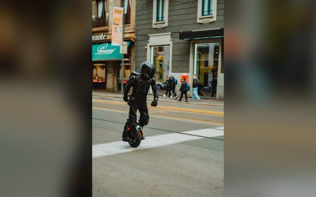 Rider in protective gear on an electric unicycle