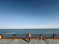 Rider on a hoverboard along the seafront