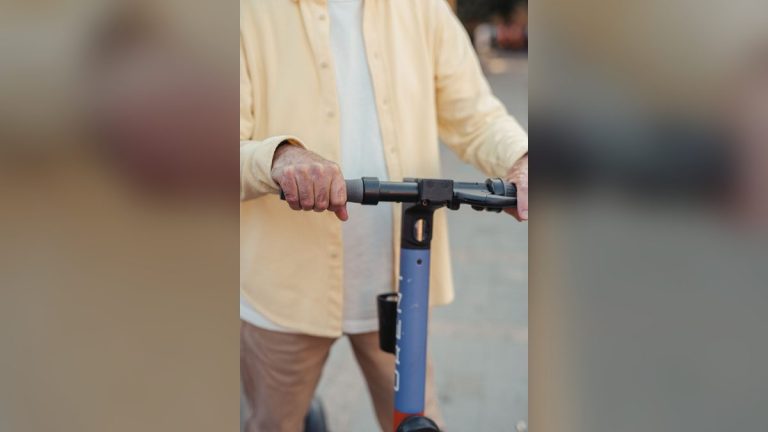 Rider's hands on electric scooter handlebars