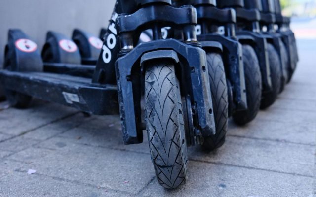 Row of parked electric scooters, close-up of the wheels