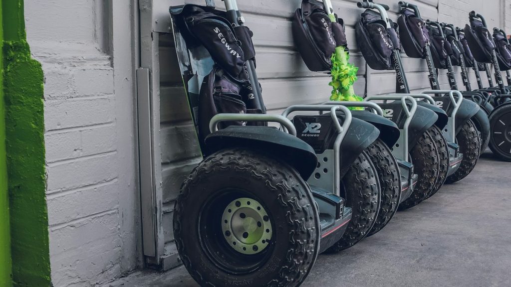 Self-balancing scooters parked beside a wall