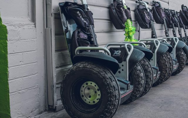 Self-balancing scooters parked beside a wall
